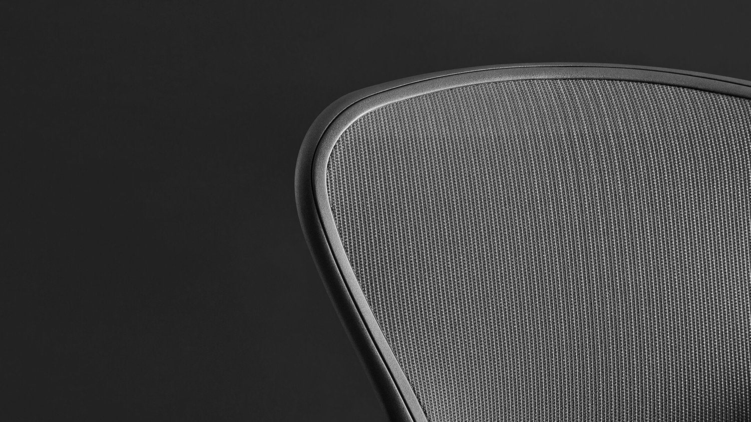 Close-up of the mesh pelicle suspension on the back of a graphite Aeron office chair