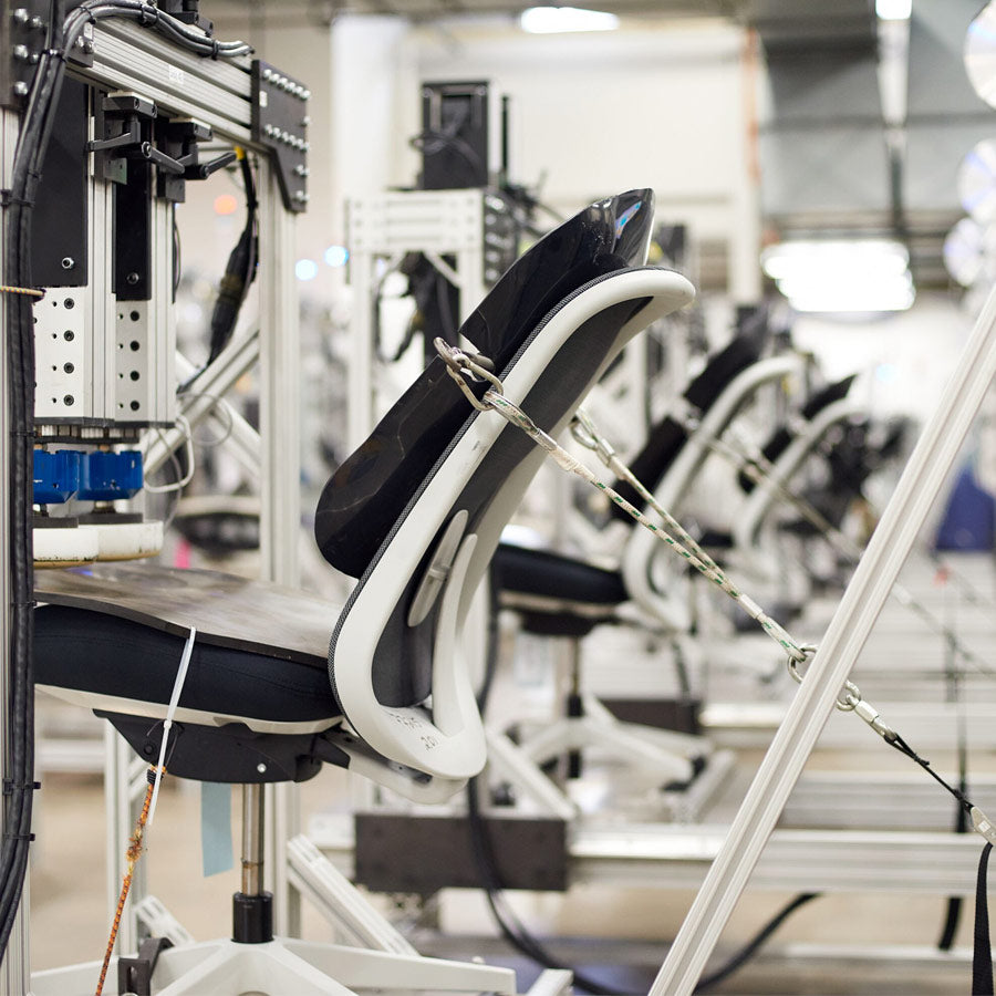 Foto eines Herman Miller-Stuhls, der im Herman Miller-Testlabor auf Haltbarkeit getestet wird